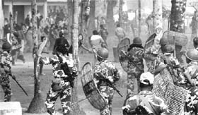 Security in action against Gorkha Janmukti Morcha (GJM) supporters during a clash following the dismantling of a GJM camp by a joint team of the state police and CRPF at Sibchu in Malbazar subdivision of Jalpaiguri district