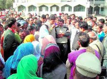 Local MLA Rakesh Pathania tries to pacify villagers and relatives of deceased Naresh Kumari on the premises of civil hospital in Nurpur on Wednesday