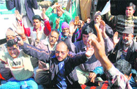 Members of the Tehreek-e-Insaf Jammu stage a protest in support of their demands at Mubarak Mandi in Jammu