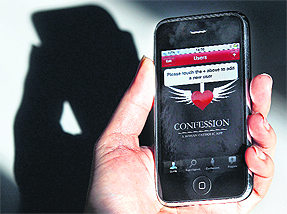 A man holds an iPhone with a new application aimed at helping Catholics to confess.