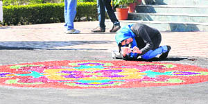 A foreigner captures a rangoli at the National Dairy Research Institute in Karnal.
