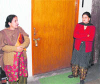 Kamla Patial (R), MC president, in front of the locked door of the EO office in Dharamsala on Thursday.