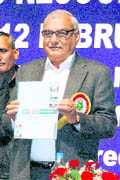 Chief Minister BS Hooda releases the souvenir of the National Town and Country Planners Congress in Panchkula. 