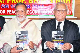 Ved Bhasin (right), chairman, Kashmir Times Group of Publications, releases book of Panthers Party chief Bhim Singh (left) in Jammu