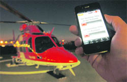 A spokesperson of Swiss air rescue (REGA) shows the new iRega iPhone rescue application at Zurich Airport in Kloten, February 8, 2011. The smartphone application sends the applicants position to the rescuers and was used for the first time successfully during the past weekend.