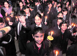 Students of St Josephs Academy take out a candlelight march in Dehradun on Friday