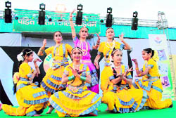 Girls perform at the Basant Mela in Dehradun on Friday