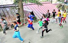 Girls run during a racing contest organised by the District Youth Services in Shimla on Friday