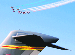 Surya Kiran aerobatic team performs on the third day of the 8th Aero India show at Yehalanka air base in Bangalore