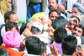Supporters of two Congress groups engage in a scuffle at the entrance to the main stage of the rally held at Rampura Phul on Friday.