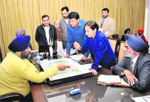 Deputy Chief Minister Sukhbir Badal holds a meeting to review the progress of the Golden Temple entrance plaza in Chandigarh on Friday.