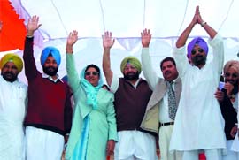 PPCC chief Captain Amarinder Singh and CLP leader Rajinder Kaur Bhattal wave to the gathering during a Congress rally organised at Rampura Phul in Bathinda district on Friday. Also seen in the picture from right are Capt Amarinder Singhs son Raninder Singh, Amritsar MLA OP Soni, Rampura Phul MLA Gurpreet Singh Kangar and Nathana MLA Ajaib Singh Bhatti. 