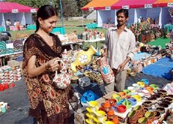A visitor selects pieces of pottery put on display at the ongoing SARAS (Sale of Articles of Rural Artisans Society) Mela on the premises of the Government Rajindra College in Bathinda