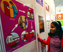 A girl looks at the stamps put on display in the World Philatelic Exhibition at Pragati Maidan in New Delhi on Saturday