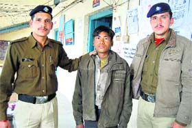 A teenaged ragpicker in the custody of the police in Mussoorie