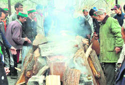 Relatives at the cremation of Manisha Devi (inset) in Jhalwari on Saturday.