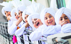 Kids break into a grin on seeing this photographer as they await their turn to perform at the annual prize distribution function of Green Land Convent School, Civil Lines, in Ludhiana