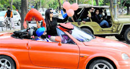 A woman wears love on her sleeve as youngsters in a jeep look on, on the eve of the Valentines Day in Chandigarh on Sunday.
