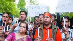 Students take part in a candlelight march to protest against the rising cases of women harassment, at Jantar Mantar in New Delhi