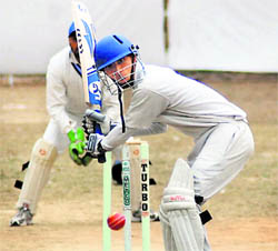 A player focuses on the ball in the 60th District Cricket League in Dehradun on Sunday.
