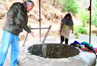 A man points at the Wishing Well near Mussoorie.