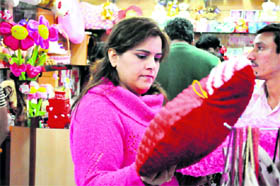 A woman buys a heart-shaped gift in Haridwar on Sunday.