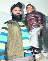 A man carries Latesh Kumar Gupta in his arms in Dehradun on Sunday