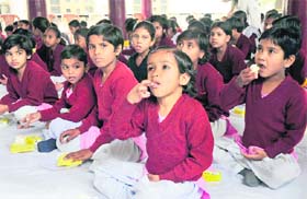 SWEET GESTURE: Children of the Shradhanand orphanage enjoy cake distributed by BJP leaders to celebrate the 59th birthday of party leader Sushma Swaraj in Karnal