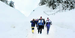 Tourists enjoy a fresh spell of snow in Gulmarg on Sunday.