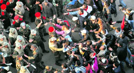 Protesters resist being removed by soldiers from Tahrir Square on Sunday.