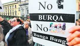 A protester holds a placard during a demonstration called if not now, when? organised by Italian women against the recent sex scandals surrounding Italian PM Silvio Berlusconi in Naples on Sunday. 