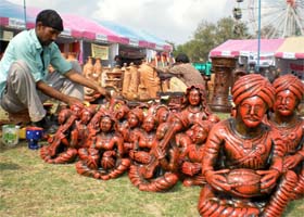 A sculptor gives final touches to his creations at the SARAS mela being held at the Government Rajindra College grounds in Bathinda