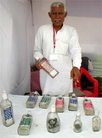 Mahender Singh, an artist from Madina village in Rohtak district of Haryana, displays the wood carvings inside the bottles at the SARAS mela in Bathinda