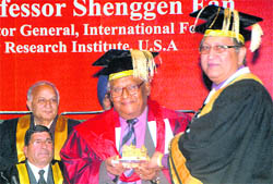 CNR Rao, eminent scientist and National Research Professor, is presented a model of the Golden Temple by Panjab University Vice-Chancellor RC Sobti at the annual convocation here on Monday.