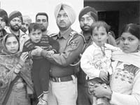 The missing children with their parents at Dera Bassi on Monday. 