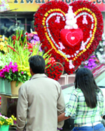 A couple looks at a bouquet in Connaught Place in New Delhi