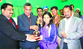 Shuttler Ruthwika Shivani from Andhra Pradesh receives the best player trophy in Haridwar on Monday.