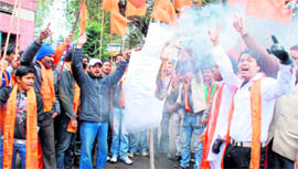 Workers of the Shiv Sena hold a demonstration in Dehradun on Monday.