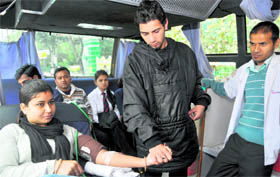 A woman donates blood in Dehradun on Monday.