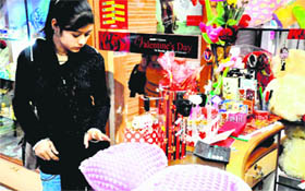 A girl looks for gifts at a shop in the Ranipur market in Haridwar on Monday.