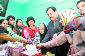 Harak Singh Rawat of the Congress cuts a cake with party workers in Dehradun on Monday.