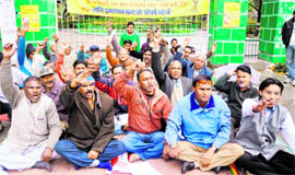 Activists hold a protest at the Gandhi Park in Dehradun on Monday.
