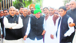 INLD supremo Om Prakash Chautala, along with party leaders, comes out of the Haryana Raj Bhawan in Chandigarh after submitting a memorandum to the Governor