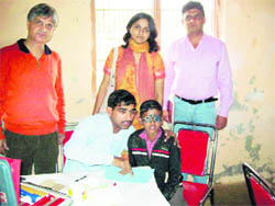 An eye surgeon examines a student at a free medical camp at Saidpur village. 