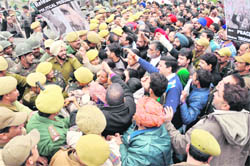 PDP party workers hold a demonstration in Jammu on Monday.