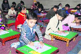 Tiny tots participate in a drawing competition during Basant Utsav at Bal Bharti Public School, Dugri, Phase II, in Ludhiana