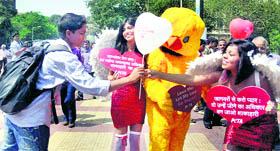 PETA activists, holding heart-shaped placards and balloons, ask people to love animals on the occasion of Valentine's Day in Mumbai on Monday.