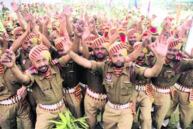Members of the 155th batch of the Punjab Armed Police celebrate after their passing-out parade in Jalandhar