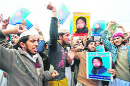Activists of Shabab-e-Islami Pakistan shout slogans in support of Mumtaz Hussain Qadri outside the Adiyala Jail in Rawalpindi on Monday.