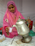 Mumtaz serves the beverage